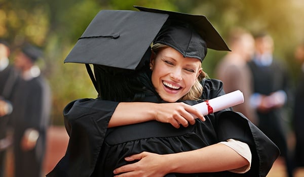 Girl at Graudation hugging High School Friend