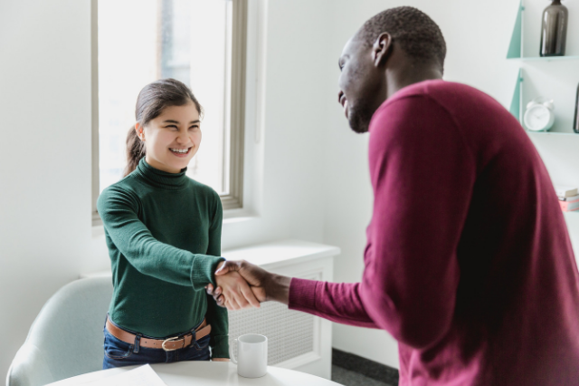 College Student Shaking Admissions Counselor Hand