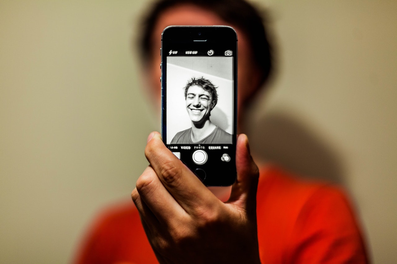 College Student Taking a Self Portrait with iPhone